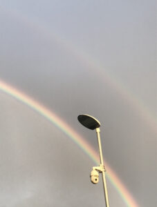 Image of security camera next to a rainbow.